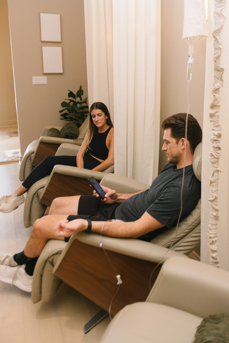 Man and woman during IV therapy and NAD+ infusion sessions